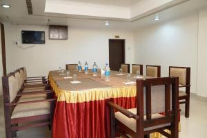 a conference room with a long table and chairs at Malanadu Tourist Home in Hosdrug