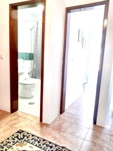 a bathroom with a toilet and a bathroom with a mirror at 4 bedrooms apartement with city view balcony and wifi at Porto 3 km away from the beach in Porto