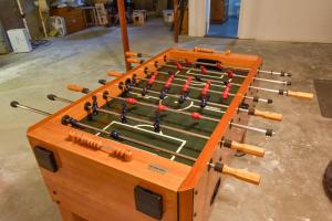 a wooden game table with balls on it at Pond Front Home with Private Dock in Brewster