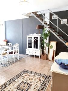 a living room with white furniture and a staircase at 4 bedrooms apartement with city view balcony and wifi at Porto 3 km away from the beach in Porto