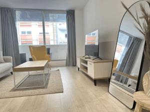 a living room with a table and a tv at New Port, Free Parking YBH1S in Vigo