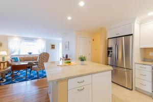 a kitchen with white cabinets and stainless steel appliances at Spacious Home by Beach Dog Welcome in Brewster