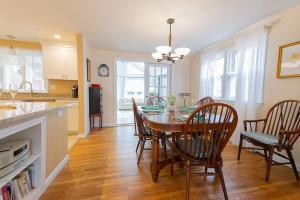 a kitchen and dining room with a table and chairs at Spacious Home by Beach Dog Welcome in Brewster