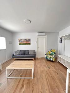 a living room with a couch and a table at Benicasim Village by Tucasanlaplaya in Benicàssim
