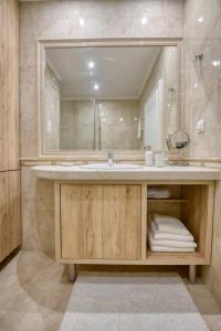 a bathroom with a sink and a mirror at Apartment Grand Karavel Centre in Varna City