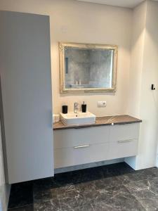 a bathroom with a sink and a mirror at Forest Hideaway Near Akureyri in Akureyri