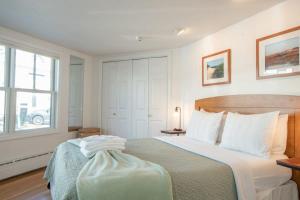 a bedroom with a bed and a window at Gorgeous water views in the center of town in Provincetown