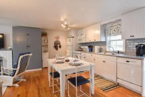 a kitchen with a white table and chairs in it at 1 2 Mile to Nantucket Sound Beaches in Dennis
