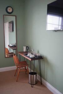 einen Tisch und einen Stuhl in einem Zimmer mit Spiegel in der Unterkunft The Alma Taverns Boutique Suites - Room 4 - Hopewell in Bristol