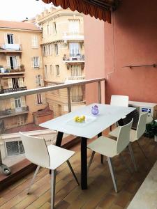 a table and chairs on a balcony with a view at Monaco Studio "907" in Monte Carlo