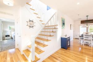 a white staircase in a home with a dining room at Stunningly Decorated Home with Hot Tub in Yarmouth +44 photos