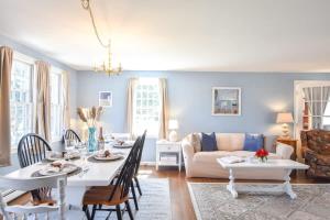 a living room with a table and a couch at Sleeps 8 Minutes to Nauset Beach in Orleans