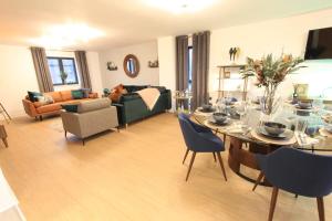 a living room with a table and chairs and a couch at Cabot Mews Apartment 9 in Bristol