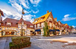 a street in a town with a building at L'Orée du Golf - Maison Deauville 8 personnes in Saint-Arnoult