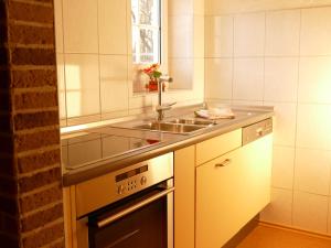 a kitchen with a sink and a stove at Ferienhaus Waldwinkel in Wrexen