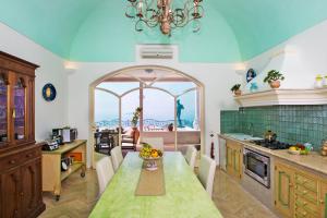 a kitchen with a table with a bowl of fruit on it at Villa Santa Chiara Positano Suites in Positano