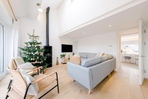 a living room with a christmas tree and a couch at Beautiful 3 Bedroom Luxury House On The Quayside Of The Harbour in Bristol