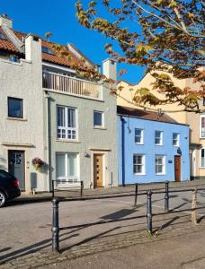 a row of houses on the side of a street at Beautiful 3 Bedroom Luxury House On The Quayside Of The Harbour in Bristol