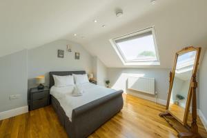 a bedroom with a bed and a large window at North Street - 2 Bedroom Apartment - Hopewell in Bristol