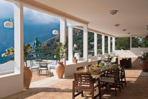 a dining room with a view of the ocean at Villa Santa Chiara Positano Suites in Positano