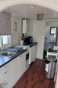a kitchen with a sink and a counter top at Chalet 24 in Leysdown-on-Sea
