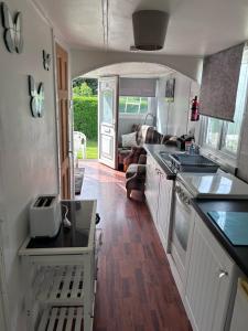 a kitchen with a sink and a stove at Chalet 24 in Leysdown-on-Sea