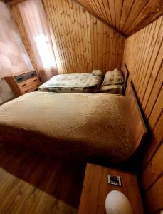 an overhead view of a bed in a wooden room at Forest Gamp in Dilijan