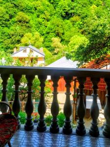 a balcony with a view of a house at Forest Gamp in Dilijan