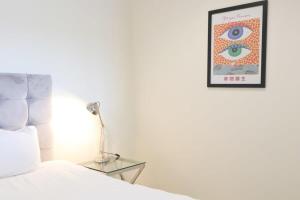 a bedroom with a bed and a picture on the wall at Flat 14 Southey House in Bristol