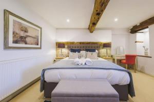 a bedroom with a bed with two stuffed animals on it at The Granary- Hopewell in Bristol