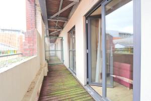 an empty corridor of a building with glass doors at City Centre 1 Bed Apartment in Bristol
