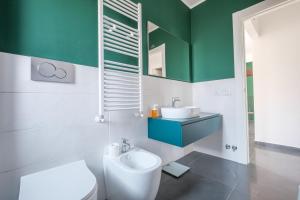 a bathroom with a toilet and a sink at Ninai Sea Holiday Apartment 2 in Furci Siculo +15 photos