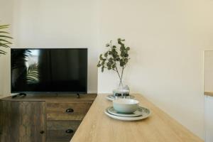 a table with a cup of coffee and a tv at Grange Road Studio 4 in Bristol