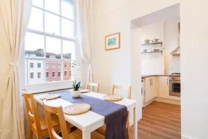 a kitchen and dining room with a table and a window at Kingsdown 2 bed in Bristol