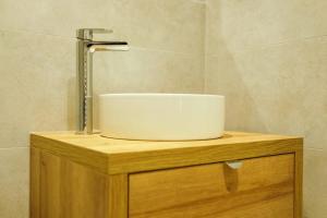 a sink sitting on top of a wooden cabinet at Hotwells apartments flat 2 - Hopewell in Bristol