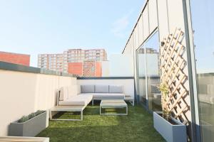 a balcony with a couch and a table on a building at Cooperage 3 bedroom house in Bristol