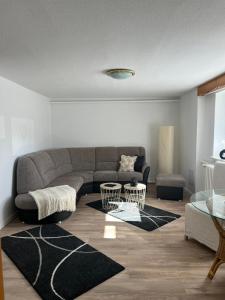 a living room with a couch and a table at Erzhof Nassau- Ferienwohnung an der Loipe in Bienenmühle