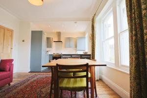 a kitchen with a table and chairs in a room at Spacious 2 storey penthouse flat, fantastic views! in Bristol