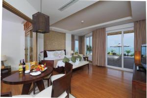 a living room with a table and a living room with a couch at The Cliff Residence in Mui Ne