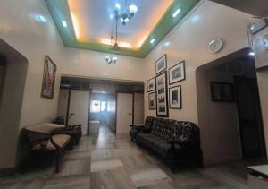 a living room with a couch and a table at Hotel Rupali in Mumbai