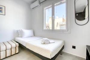 a bedroom with a bed and a window at Anais - Solo traveller rooftop in Athens