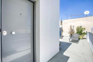 a pivot door on a house with a patio at Anais - Solo traveller rooftop in Athens