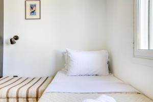 a small bedroom with a bed and a window at Anais - Solo traveller rooftop in Athens