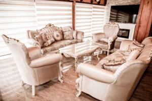 a living room with couches and chairs and a table at Lux Villa Emina in Tuzla