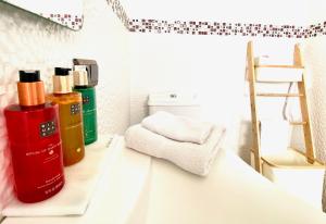 a bathroom with a toilet and a shelf with towels at Zenit Olhao B & B with sea view rooftop terrace in Olhão