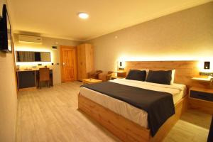 a bedroom with a large bed in a room at Sandal Otel in Trabzon