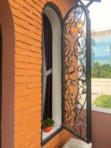 a iron gate on a window with a plant at The Nest Homestay in Ho Chi Minh City