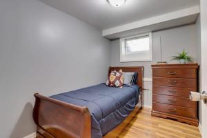 a bedroom with a blue bed and a dresser at Beautiful 2 Bedroom across from The House of Representatives in Washington
