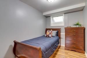 a bedroom with a bed and a dresser at Beautiful 2 Bedroom across from The House of Representatives in Washington