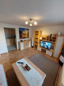 a large living room with a television and a table at Appartmenthaus Gingst in Gingst